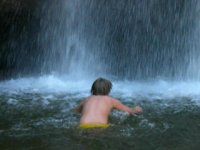 Matthew going through the waterfall