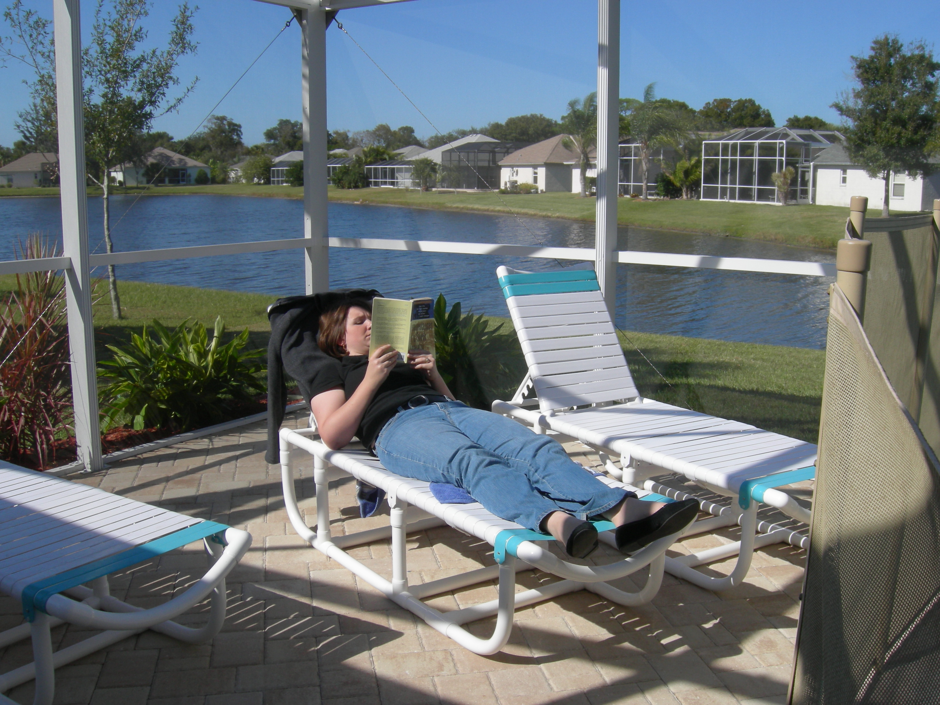 Meredith enjoying reading by the pool