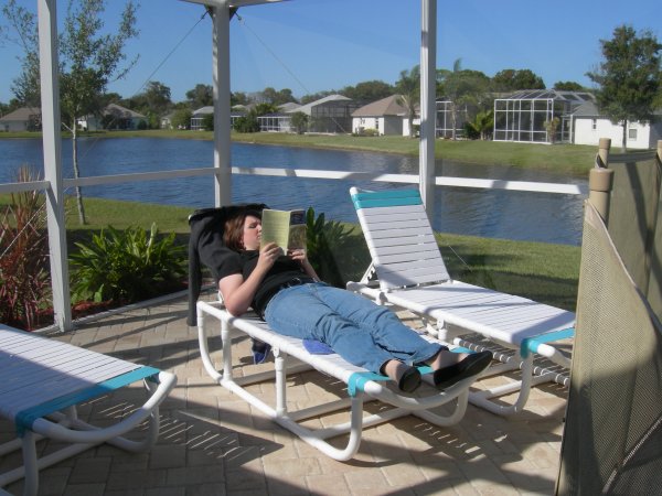 Meredith enjoying reading by the pool