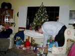 Grandpa checking a book he got as a present; Jamie handing out gifts