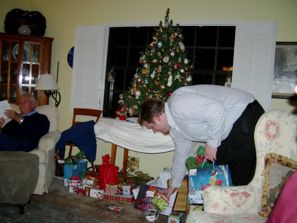 Grandpa checking a book he got as a present; Jamie handing out gifts