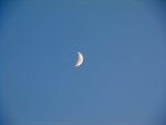 the sun is setting, the moon is up